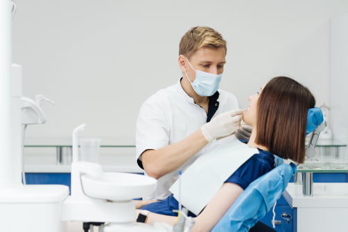 A dentist selecting a veneer shade for a patient during cosmetic and restorative dental treatment planning in North York.
